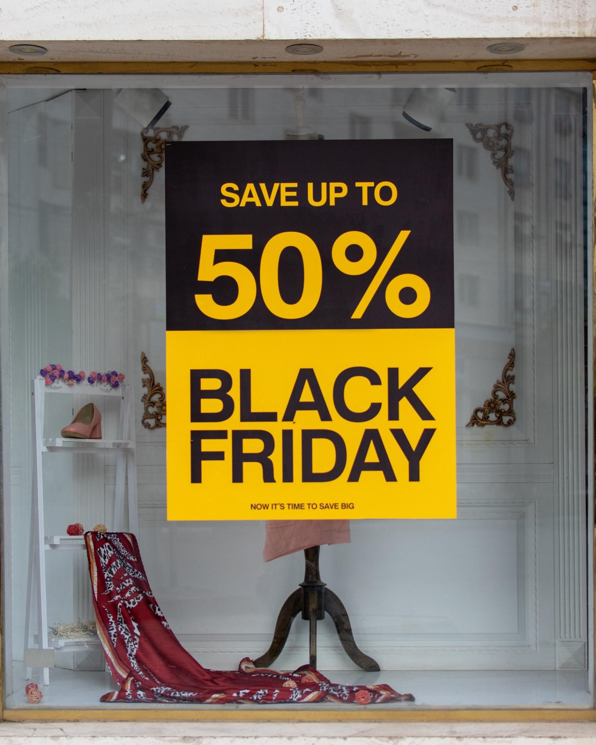 Shop front with 50% off Black Friday poster